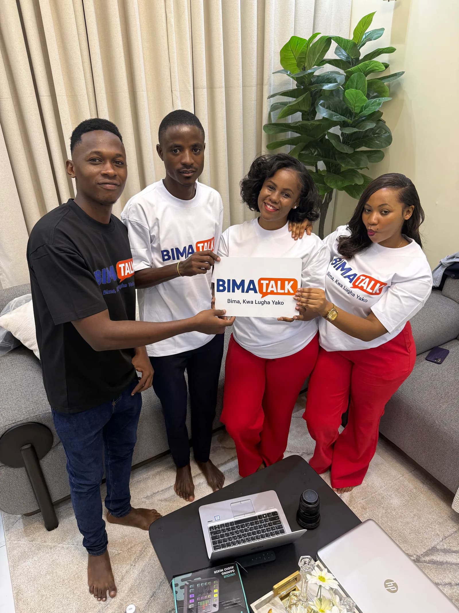 BimaTalk community team holding a BimaTalk sign