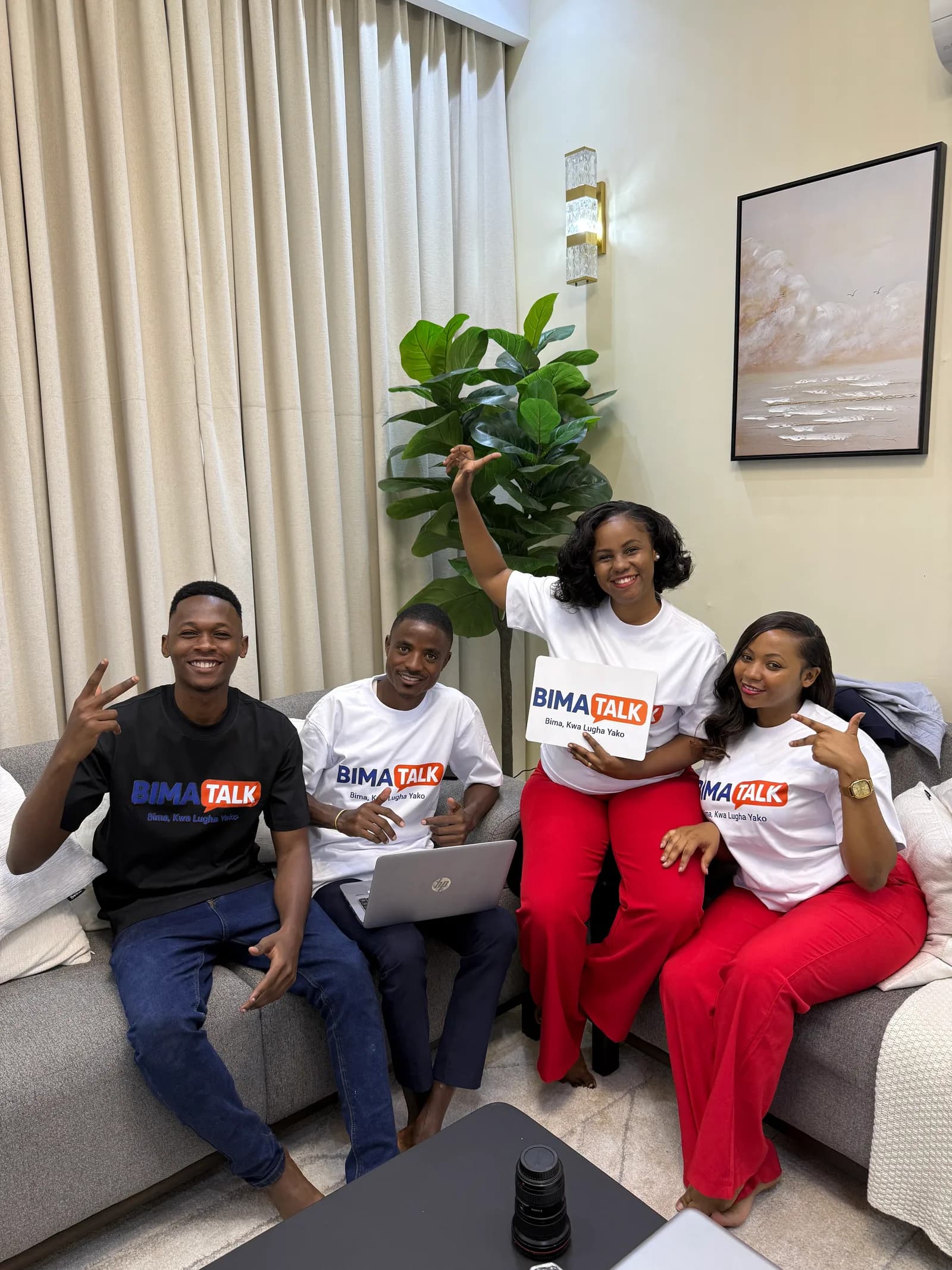 BimaTalk team seated together in branded shirts